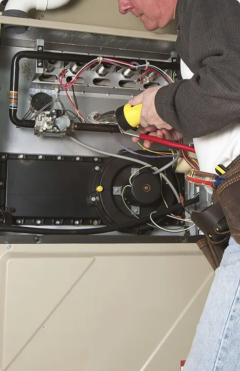 HVAC Contractor fixing a furnace