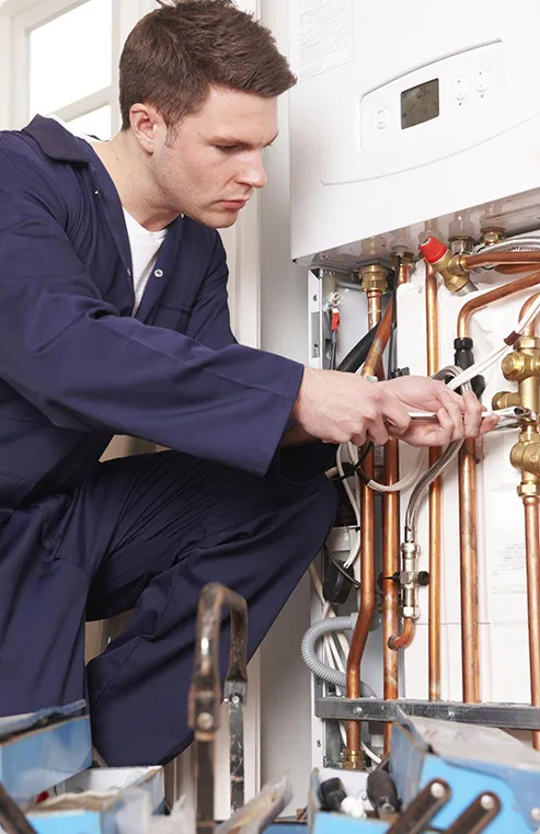 Technician fixing a tankless water heater