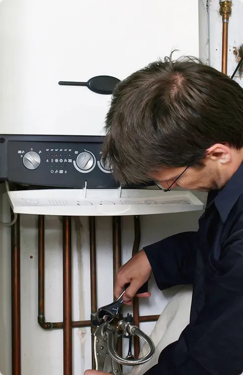 worker performing a water heater repair