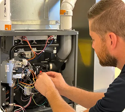 HVAC technician repairing the cabling of an HVAC system