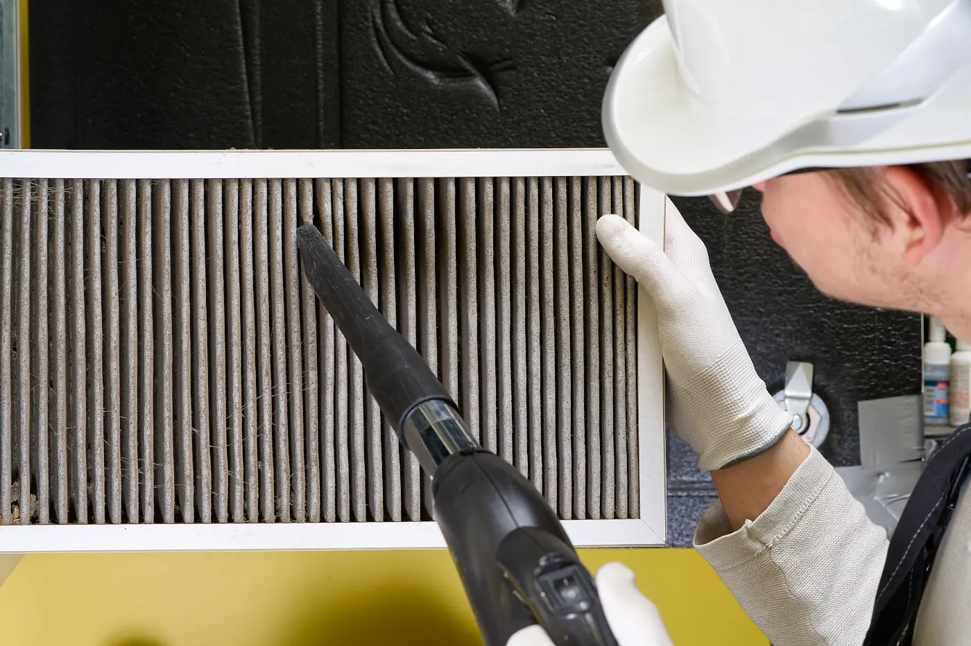 HVAC Contractor cleaning a filter
